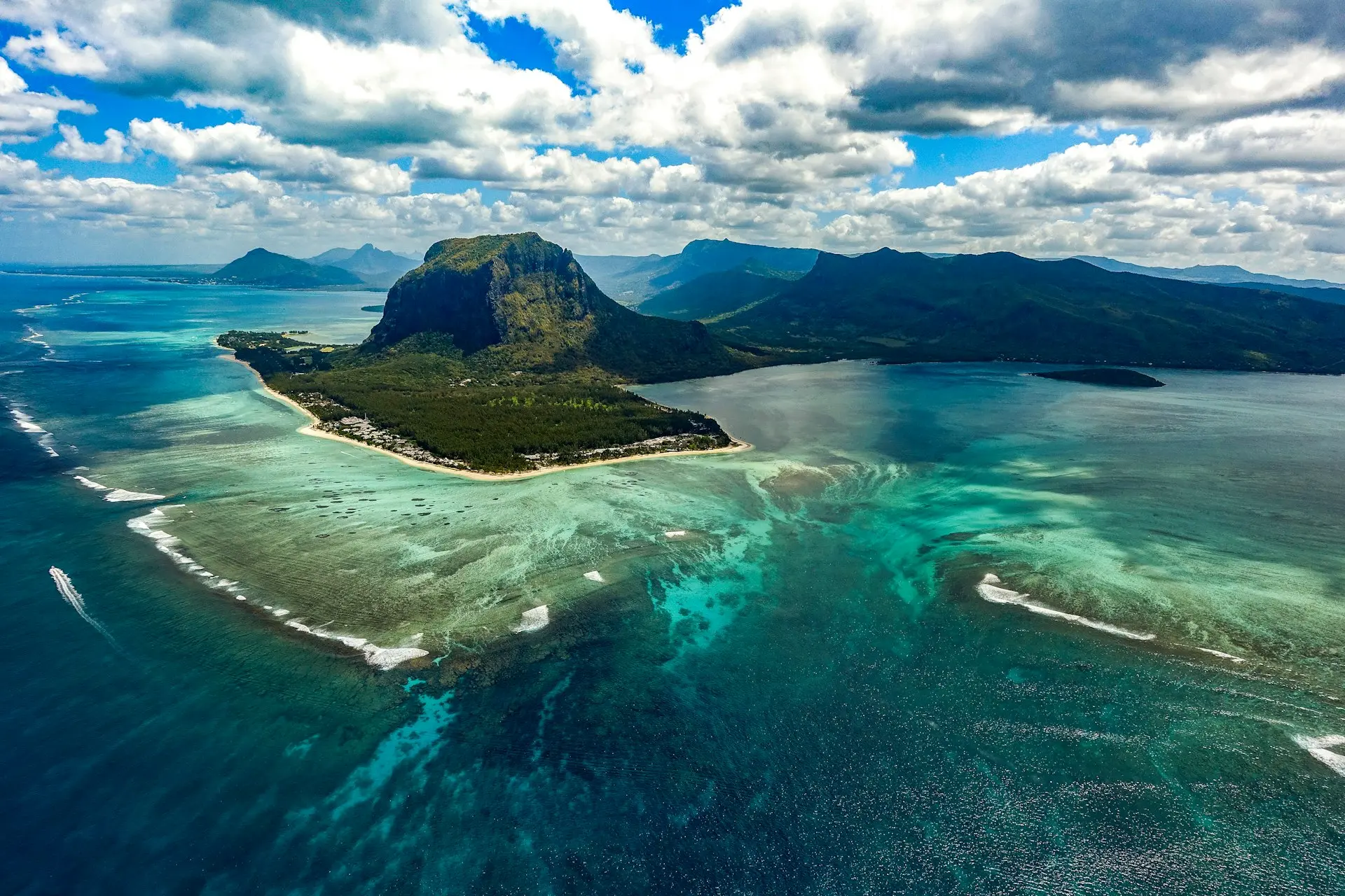 green island in the middle of body of water